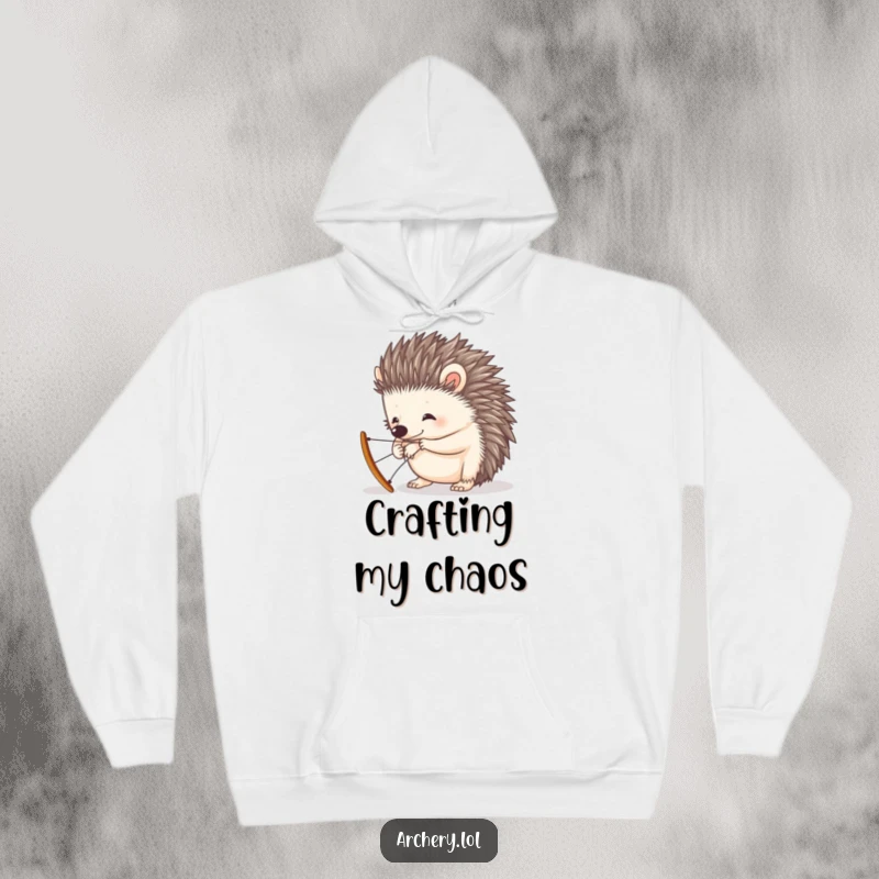 Funny hoodie featuring a curious hedgehog diligently attempting to string a small, decorative bow, looking adorable.