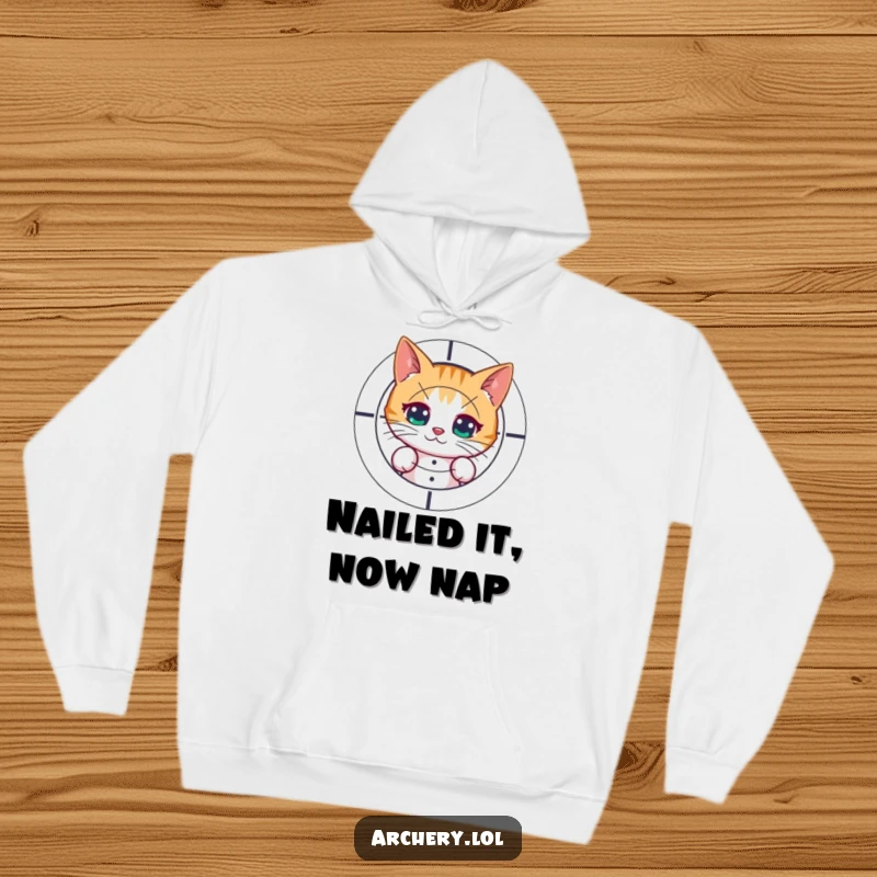 Funny hoodie with a curious cat peeking from behind a target, post-shot. Cozy and humorous apparel for cat lovers.