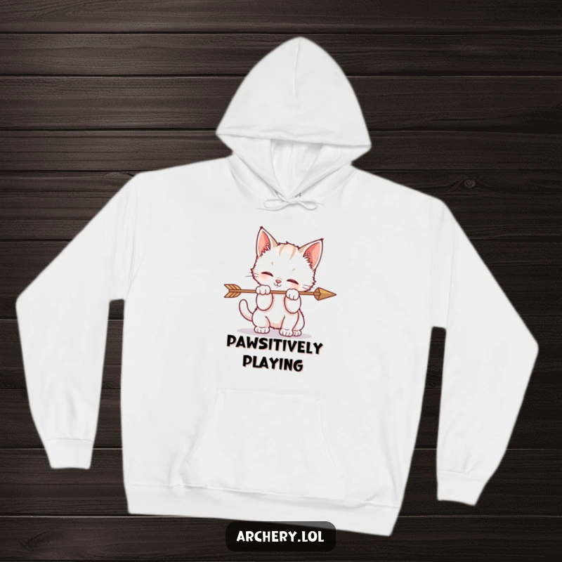 Funny hoodie graphic of a kitten hilariously batting at an arrow, showcasing playful, adorable mischief.
