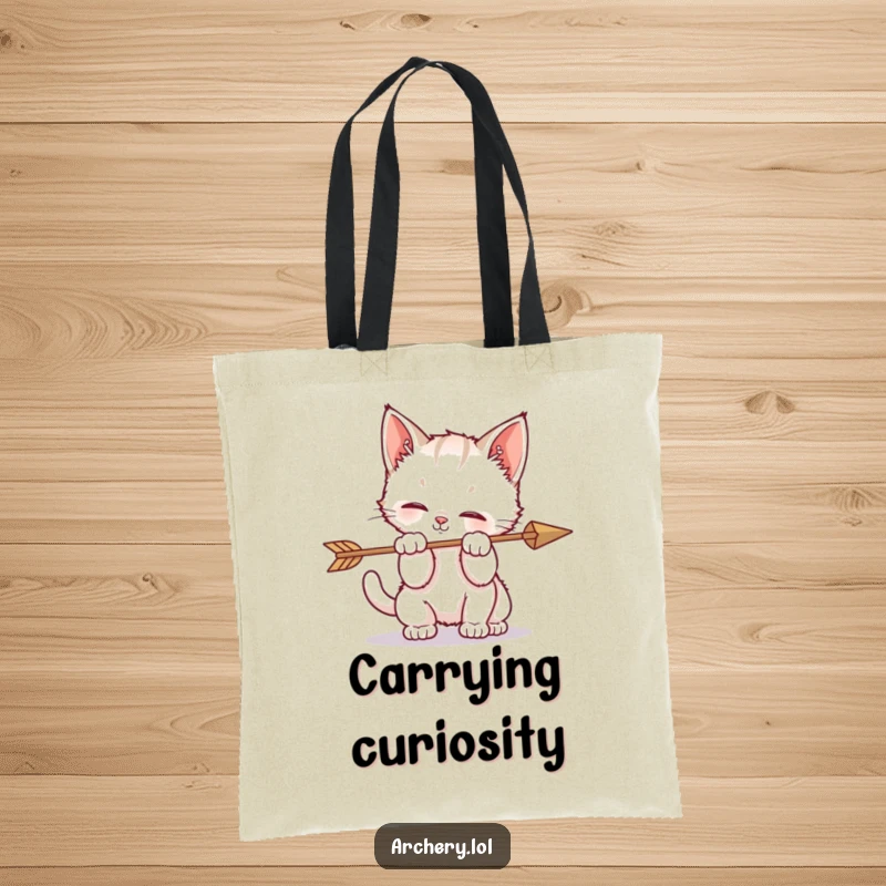 Funny tote bag featuring a kitten playfully batting at an arrow, embodying irresistible feline curiosity and chaos.