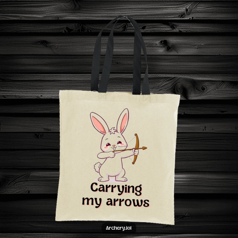Funny tote bag with a happy bunny drawing a bow, aiming with a smile. Durable and humorous, perfect for shopping or as a gift.